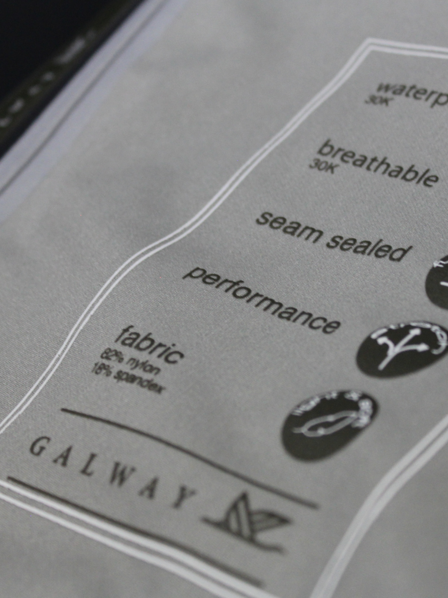 Close-up of a label with text and logos on a gray background

