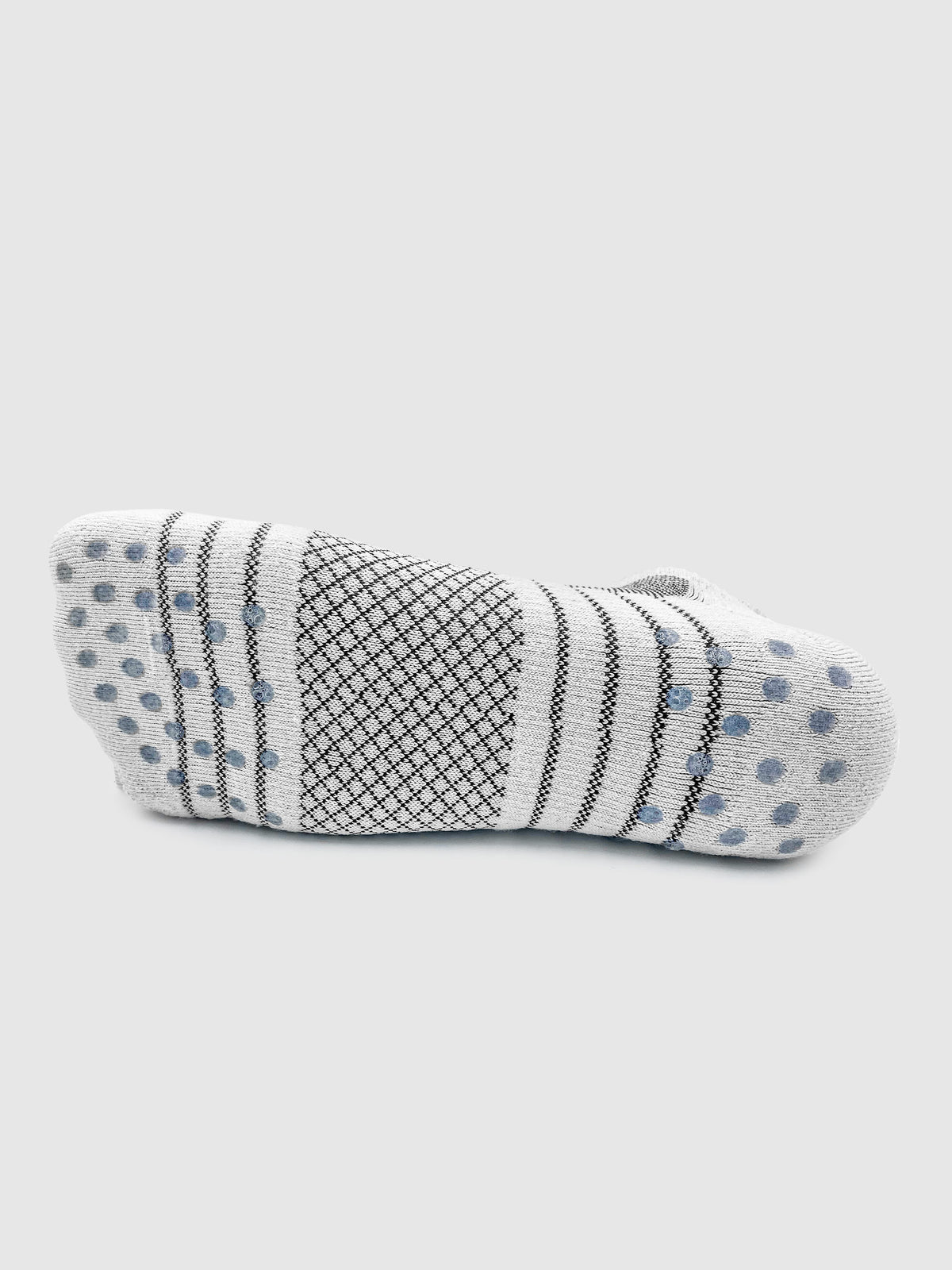 The bottom of a white and gray golf sock