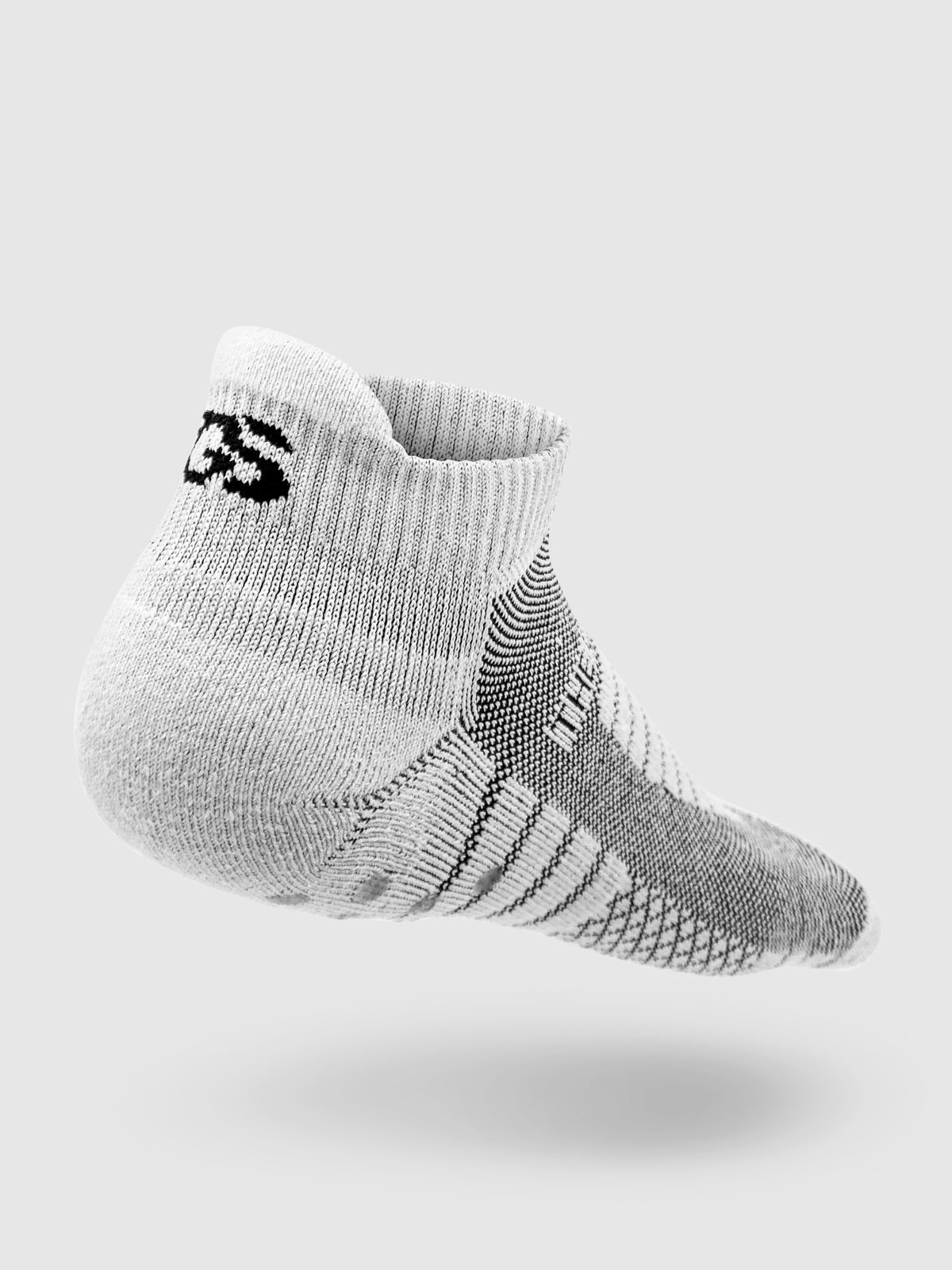 The back of a white and gray golf sock